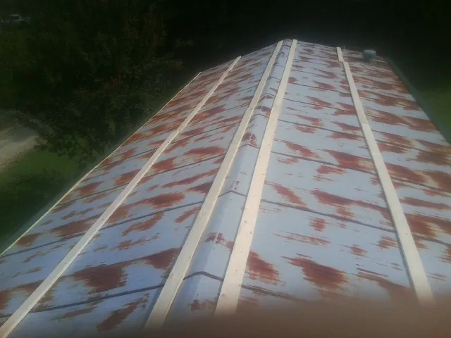 Rusted metal roof panels with new wood purlins before replacement — Storm Damage Roof Repair in Wimauma by Roofing Brothers